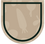 The image shows a beige shield-like emblem with a dark green border. The background features faint vegetable silhouettes, including a carrot, onion, and other root vegetables.